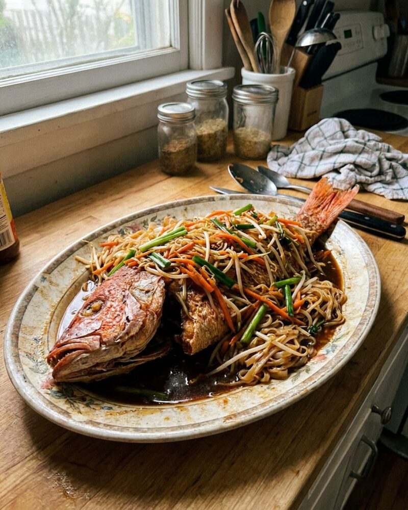 Whole fried Thai fish over stir-fried rice noodles